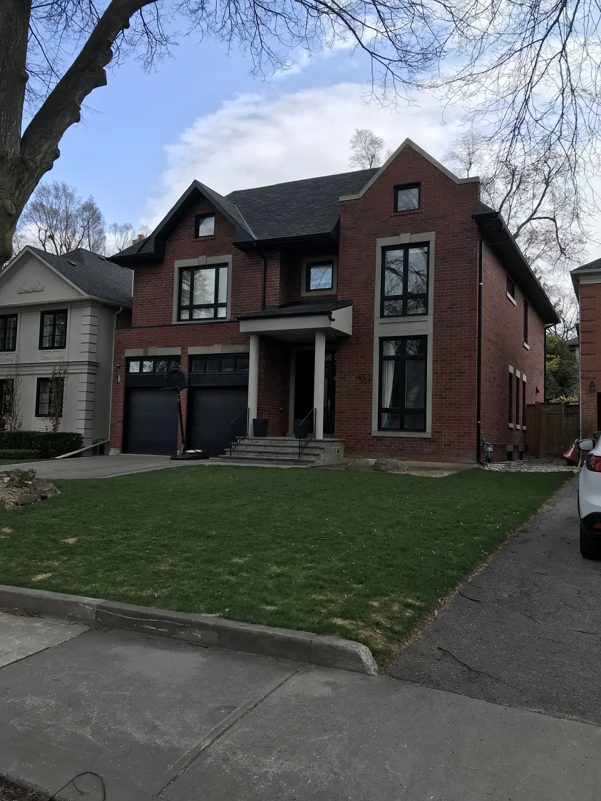 Brick two-storey home with a dark shingle roof