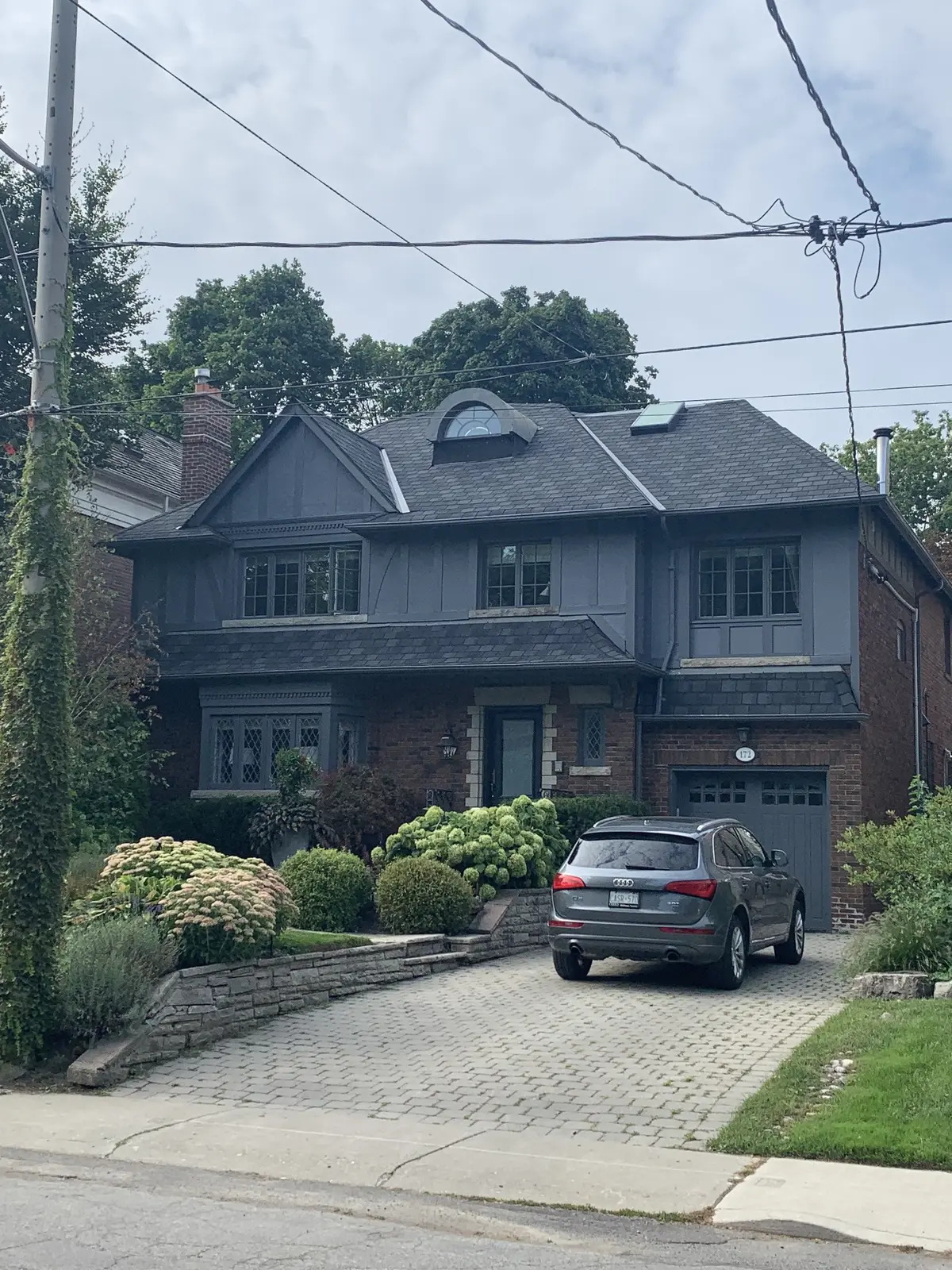 Grey two-storey home with a dark asphalt shingle roof
