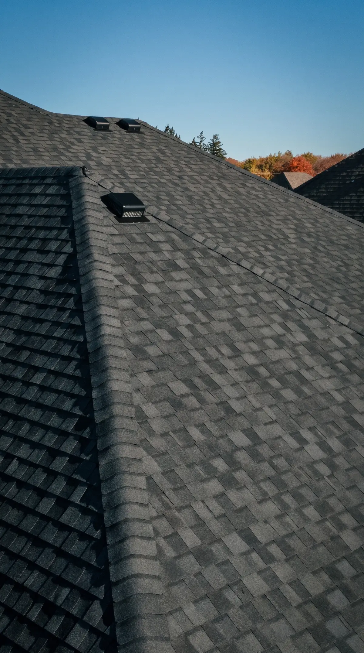 Close-up of the new dark architectural shingles and roof vents on the King City home