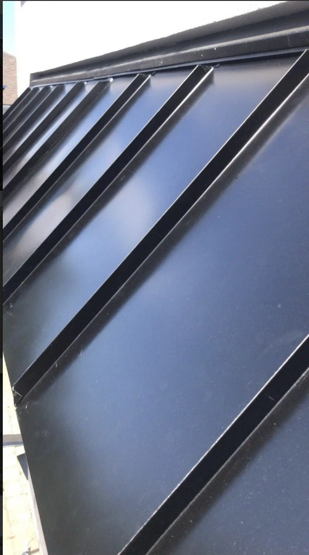 Close-up of a black standing seam metal roof